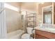 Bright bathroom featuring a granite vanity, modern fixtures, and a shower-tub combination at 3881 E Birchwood Pl, Chandler, AZ 85249