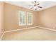 Neutral-toned bedroom with ample natural light, featuring neutral carpeting, a ceiling fan, and shuttered windows at 3881 E Birchwood Pl, Chandler, AZ 85249