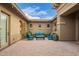 Beautiful courtyard with brick pavers, a cozy seating area, and elegant string lights overhead at 3881 E Birchwood Pl, Chandler, AZ 85249