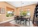 Inviting dining room featuring a wood table and backyard views through two sunlit windows at 3881 E Birchwood Pl, Chandler, AZ 85249