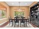 Dining room featuring seating for six, a large window, and wood floors at 3881 E Birchwood Pl, Chandler, AZ 85249