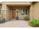 Inviting entryway with a wood door, sidelight windows, and beautiful landscaping at 3881 E Birchwood Pl, Chandler, AZ 85249