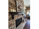 Stone fireplace with a black mantel and a wreath at 3881 E Birchwood Pl, Chandler, AZ 85249