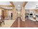 Hallway with wood floors leads to the dining room and the living room with a stone fireplace at 3881 E Birchwood Pl, Chandler, AZ 85249