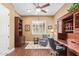 Well-lit home office featuring built-in storage, a cozy reading nook, and hardwood floors at 3881 E Birchwood Pl, Chandler, AZ 85249