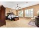 Spacious main bedroom with neutral carpeting, a ceiling fan, and shuttered windows providing ample natural light at 3881 E Birchwood Pl, Chandler, AZ 85249