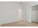 Bedroom with carpet and closet, showing view into the hallway at 3906 N 103Rd Ave, Avondale, AZ 85392