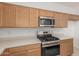 A clean, organized kitchen with stainless steel appliances and matching cabinetry at 3906 N 103Rd Ave, Avondale, AZ 85392