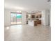 Open concept living space with tile floors, kitchen island, and sliding glass doors to the backyard at 3906 N 103Rd Ave, Avondale, AZ 85392