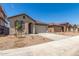 Street view of single story homes with concrete driveways and landscaped yards at 3906 N 103Rd Ave, Avondale, AZ 85392