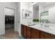 Bright bathroom featuring a double sink vanity with a walk-in closet at 39242 N Luke Cir, San Tan Valley, AZ 85140