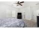 Spacious bedroom with soft carpet, ceiling fan, closet, and natural light from the window at 39242 N Luke Cir, San Tan Valley, AZ 85140