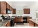 This kitchen showcases granite countertops, and black appliances, providing a functional and stylish cooking space at 39242 N Luke Cir, San Tan Valley, AZ 85140