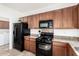 Kitchen area features granite countertops, black appliances and ample cabinet space for storage at 39242 N Luke Cir, San Tan Valley, AZ 85140