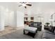 Bright living room featuring a ceiling fan, neutral tones, carpet, and tile flooring throughout at 39242 N Luke Cir, San Tan Valley, AZ 85140