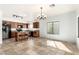 Open-concept kitchen and dining area featuring tile flooring, a chandelier, and natural light at 39242 N Luke Cir, San Tan Valley, AZ 85140