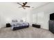 Spacious main bedroom with carpet, ceiling fan, neutral walls, and lots of natural light at 39242 N Luke Cir, San Tan Valley, AZ 85140