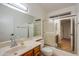 Bathroom showcasing vanity, toilet, and a shower-tub with glass doors at 3938 E Gable Ave, Mesa, AZ 85206