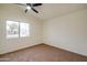 Bright bedroom features neutral carpet and a window overlooking the neighborhood at 3938 E Gable Ave, Mesa, AZ 85206