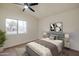 Bedroom featuring neutral walls, ceiling fan, and an expansive window at 3938 E Gable Ave, Mesa, AZ 85206