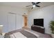 Bright bedroom featuring a ceiling fan, closet and a TV on a dresser at 3938 E Gable Ave, Mesa, AZ 85206