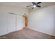 Bright bedroom featuring a ceiling fan, closet, and neutral carpet at 3938 E Gable Ave, Mesa, AZ 85206