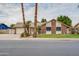 Charming single-story home featuring a lush lawn, mature landscaping, and a two-car garage at 3938 E Gable Ave, Mesa, AZ 85206