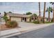 Charming single-story home featuring a lush lawn, mature landscaping, and a two-car garage at 3938 E Gable Ave, Mesa, AZ 85206