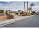 Charming single-story home featuring a lush lawn, mature landscaping, and a two-car garage at 3938 E Gable Ave, Mesa, AZ 85206