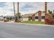 Charming single-story home featuring a lush lawn, mature landscaping, and a two-car garage at 3938 E Gable Ave, Mesa, AZ 85206