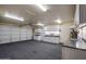 Spacious garage with ample cabinet storage, sink, and garage door at 3938 E Gable Ave, Mesa, AZ 85206