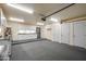 Well-lit garage featuring white cabinets and several doors at 3938 E Gable Ave, Mesa, AZ 85206