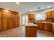 Spacious kitchen with ample cabinet storage and center island, providing plenty of countertop workspace at 3938 E Gable Ave, Mesa, AZ 85206