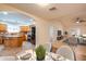 Open-concept living space featuring neutral tones, tile flooring, and a modern kitchen with island seating at 3938 E Gable Ave, Mesa, AZ 85206