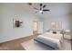 Bright main bedroom with carpet, ceiling fan, walk-in closet, ensuite bathroom and an adjacent bedroom at 3938 E Gable Ave, Mesa, AZ 85206