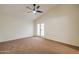 Bright main bedroom features vaulted ceiling, ceiling fan, neutral carpet and direct patio access through French doors at 3938 E Gable Ave, Mesa, AZ 85206