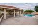 Backyard showcasing the covered patio, built-in BBQ, and swimming pool at 3938 E Gable Ave, Mesa, AZ 85206