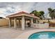 Covered poolside patio with built in barbeque offers a perfect space for entertaining and relaxing at 3938 E Gable Ave, Mesa, AZ 85206