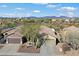 Aerial front view of home highlighting the landscape, multiple car garage, and desert setting at 40504 N Territory Trl, Anthem, AZ 85086