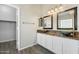 Bathroom with dual sinks and framed mirrors and walk-in closet for optimal storage at 40504 N Territory Trl, Anthem, AZ 85086