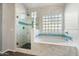 An elegant bathroom showcasing dual shower heads and glass block window accents at 40504 N Territory Trl, Anthem, AZ 85086