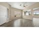 Inviting living room area with a ceiling fan, wood-look tile floor, and neutral paint at 40504 N Territory Trl, Anthem, AZ 85086