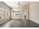 Spacious living room with wood-look tile flooring, lots of light, and neutral decor at 40504 N Territory Trl, Anthem, AZ 85086