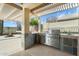 Outdoor kitchen with built-in grill perfect for entertaining at 40504 N Territory Trl, Anthem, AZ 85086