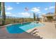 Refreshing pool with a tanning ledge, desert landscaping, and a pergola in a private backyard at 40504 N Territory Trl, Anthem, AZ 85086