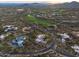 Expansive aerial shot of a golf course community surrounded by homes with lush landscaping and desert vegetation at 42237 N 107Th Pl, Scottsdale, AZ 85262