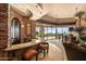 Sophisticated bar area featuring stone accents, granite countertop, and scenic views at 42237 N 107Th Pl, Scottsdale, AZ 85262