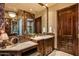 Bathroom featuring a vanity, marble countertop and elegant mirror at 42237 N 107Th Pl, Scottsdale, AZ 85262