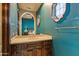 Bathroom featuring granite countertops, mirror, and blue walls at 42237 N 107Th Pl, Scottsdale, AZ 85262