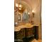 Bathroom featuring decorative walls, countertops, vanity, and unique glass sink and faucet at 42237 N 107Th Pl, Scottsdale, AZ 85262